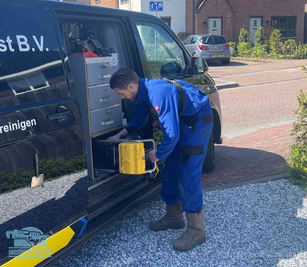 Een monteur pakt apparatuur uit de bedrijfsbus voor service aan huis, het moment om een professional in te schakelen voor een verstopte wc in Zaanstad